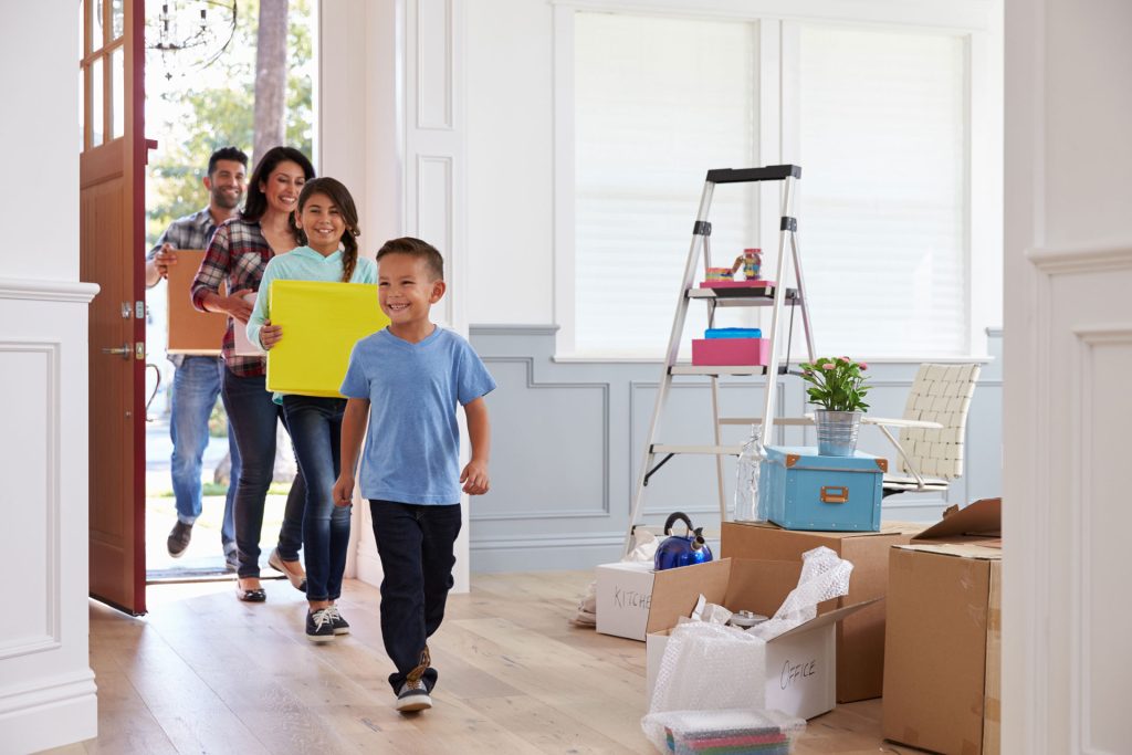 a group of people walking through a house.