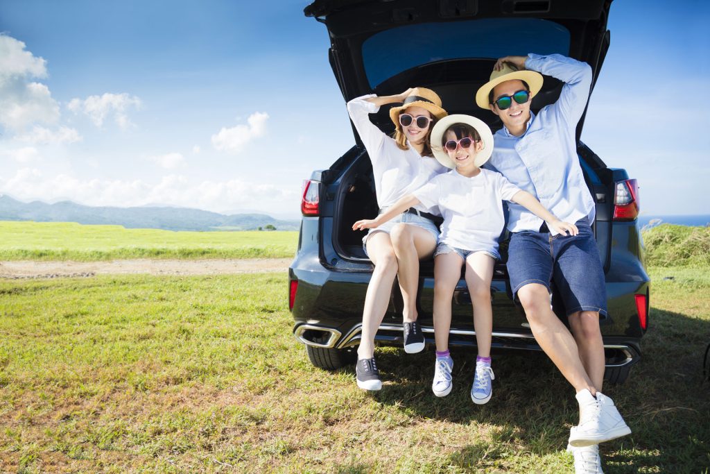 a couple of people that are sitting in the back of a car.